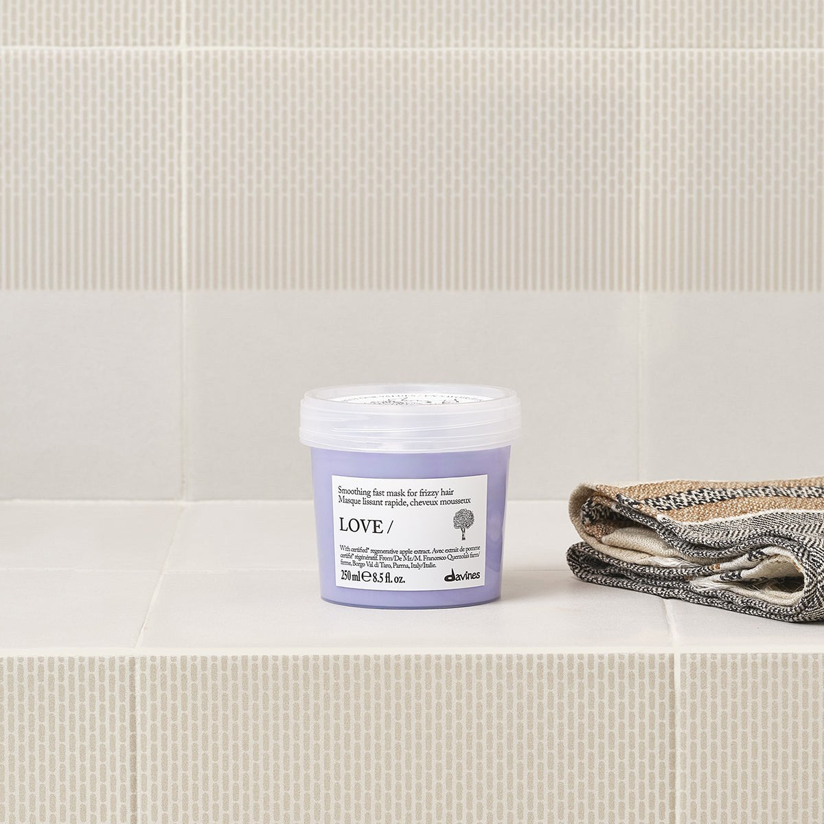 Davines LOVE Smoothing Instant Mask with the LOVE Smoothing range on a bathroom shelf